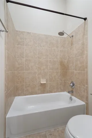 a bathroom with a bathtub and shower
