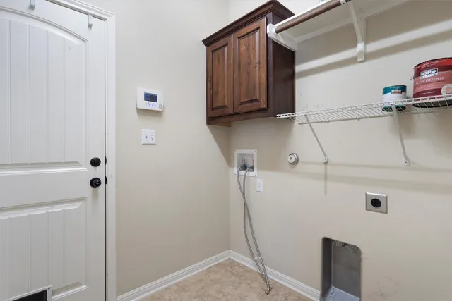 a view of storage and utility room with closet