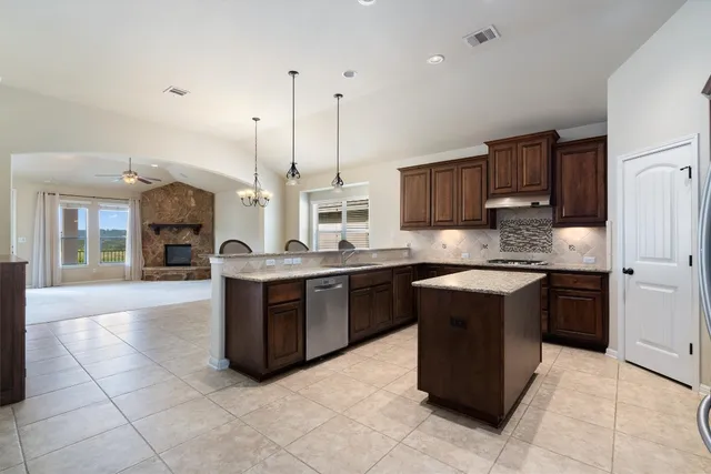a kitchen with a sink counter top space appliances and a window