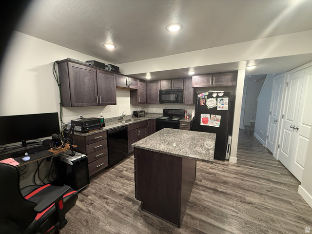 485 370 South Preston, ID 83263 - Photo 6 of 16 Kitchen with dark wood finish cabinetry, dark wood-style flooring, a kitchen island, and black appliances