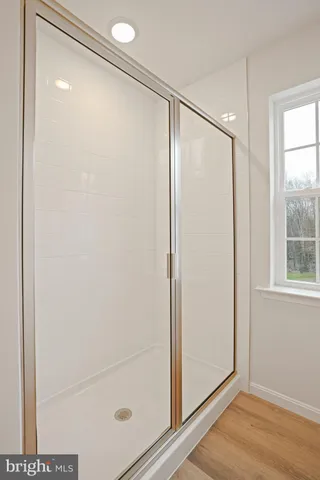 a bathroom with a glass shower door