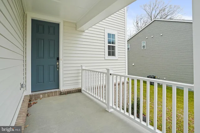 a view of a house with a wooden fence