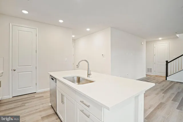 a kitchen with a sink and a refrigerator