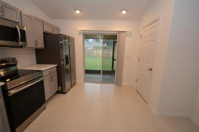 a kitchen with a refrigerator sink and stove