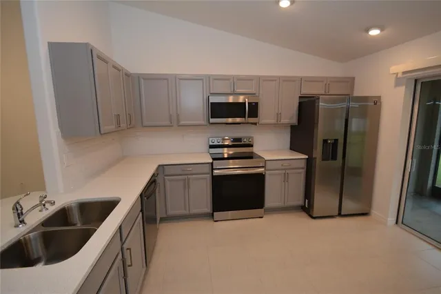 a kitchen with a refrigerator sink and microwave
