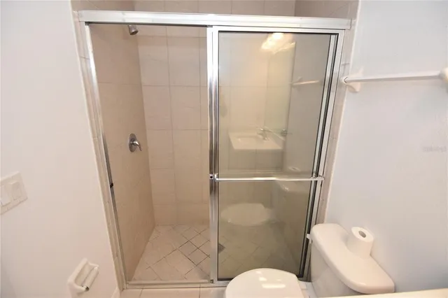 a bathroom with a shower and a toilet