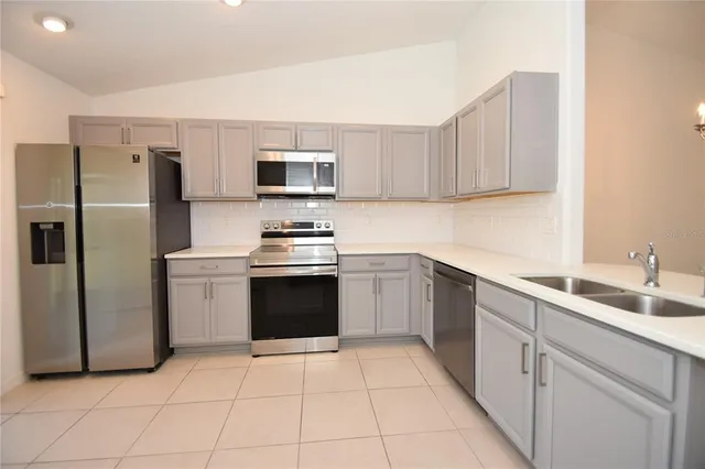 a kitchen with a sink stove and refrigerator
