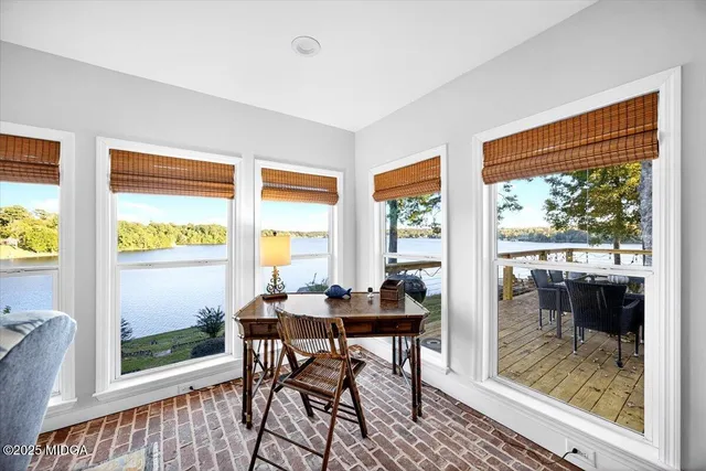 a living room with lots of furniture and clutter on the wall