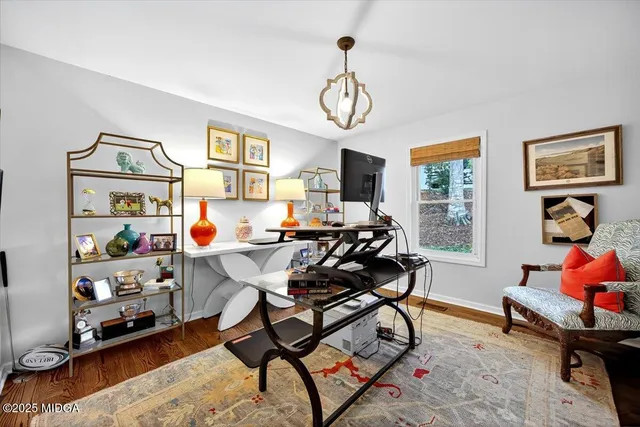 a kitchen with stainless steel appliances granite countertop a stove a sink dishwasher and a refrigerator with wooden floor