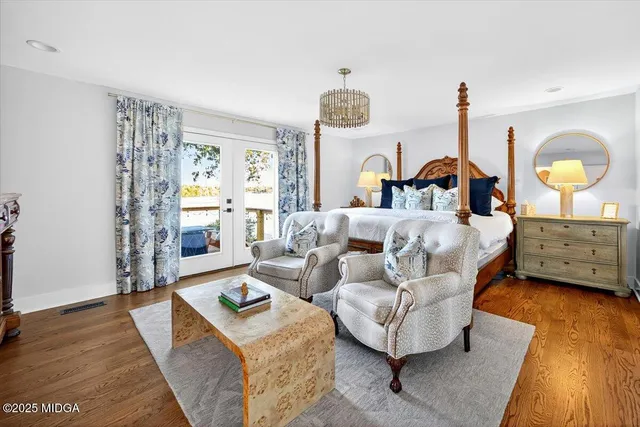 a living room with furniture and a chandelier