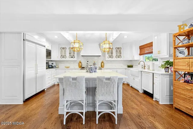 a living room with furniture a chandelier and a flat screen tv