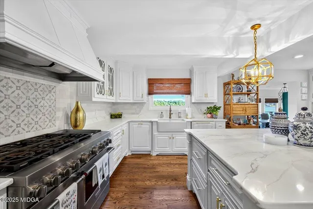 a view of a patio with a table chairs potted plants and a garden