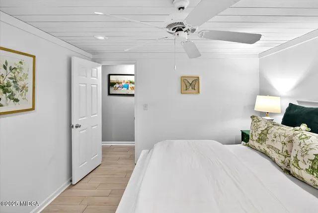 a living room with furniture a flat screen tv and a large window