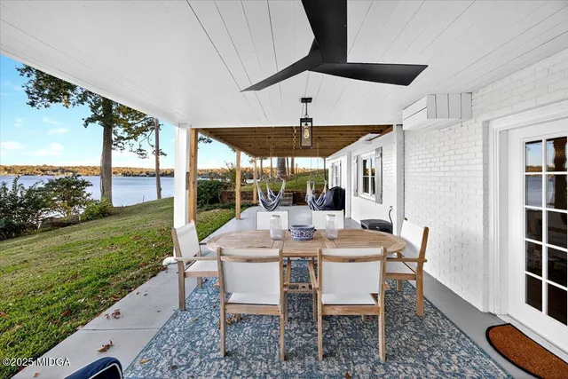 a view of a house with backyard sitting area and garden