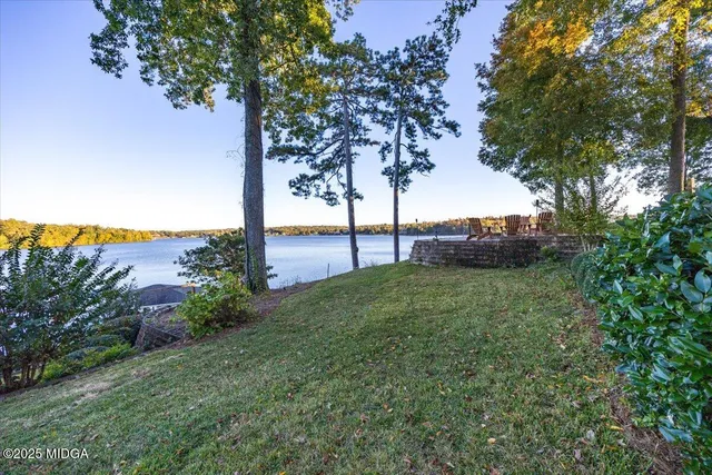 a view of a house with a yard and potted plants