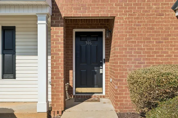 a front view of a house with a brick wall