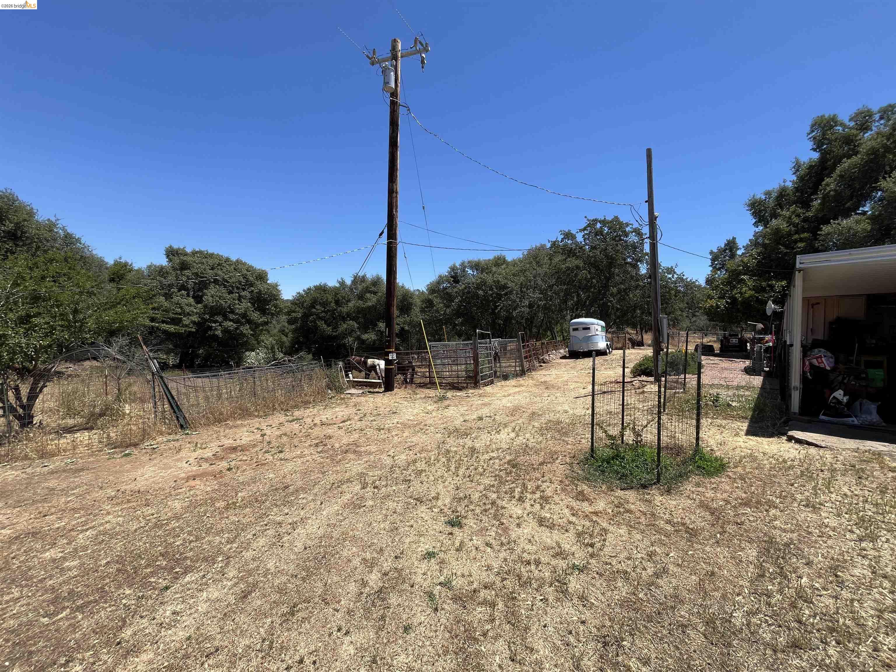 18195 Wards Ferry Road Sonora, CA 95370 - Photo 44 of 67 Expansive outdoor area with a utility pole, fencing, and mature trees