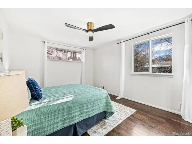 a bedroom with a bed and a painting on the wall