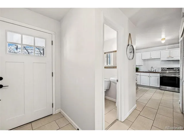 a view of kitchen with furniture and refrigerator