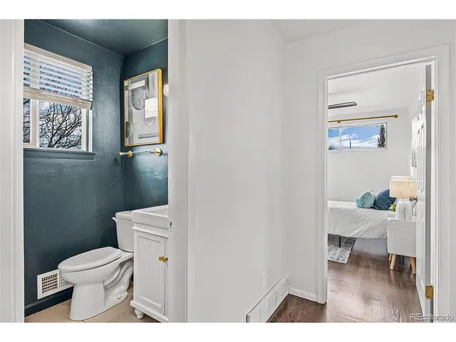 a bathroom with a toilet a sink and a window