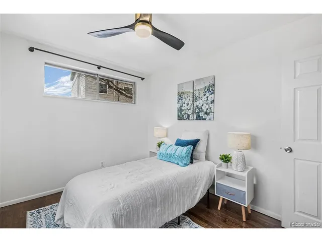 a bedroom with a bed and a painting on the wall