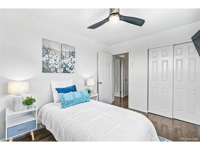 a bedroom with a bed and a painting on the wall