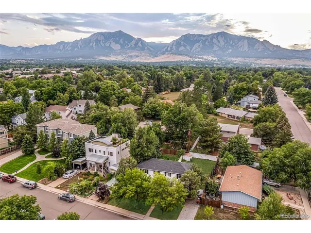 an aerial view of residential house and sandy dunes