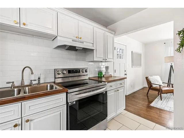 a kitchen with cabinets a sink and appliances