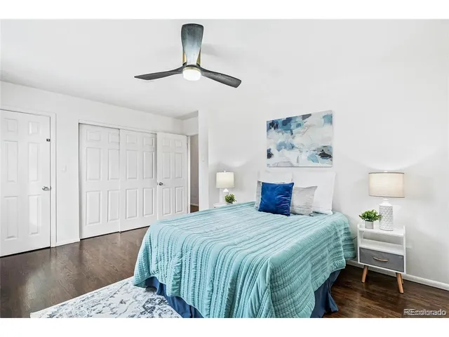 a bedroom with a bed and a painting on the wall