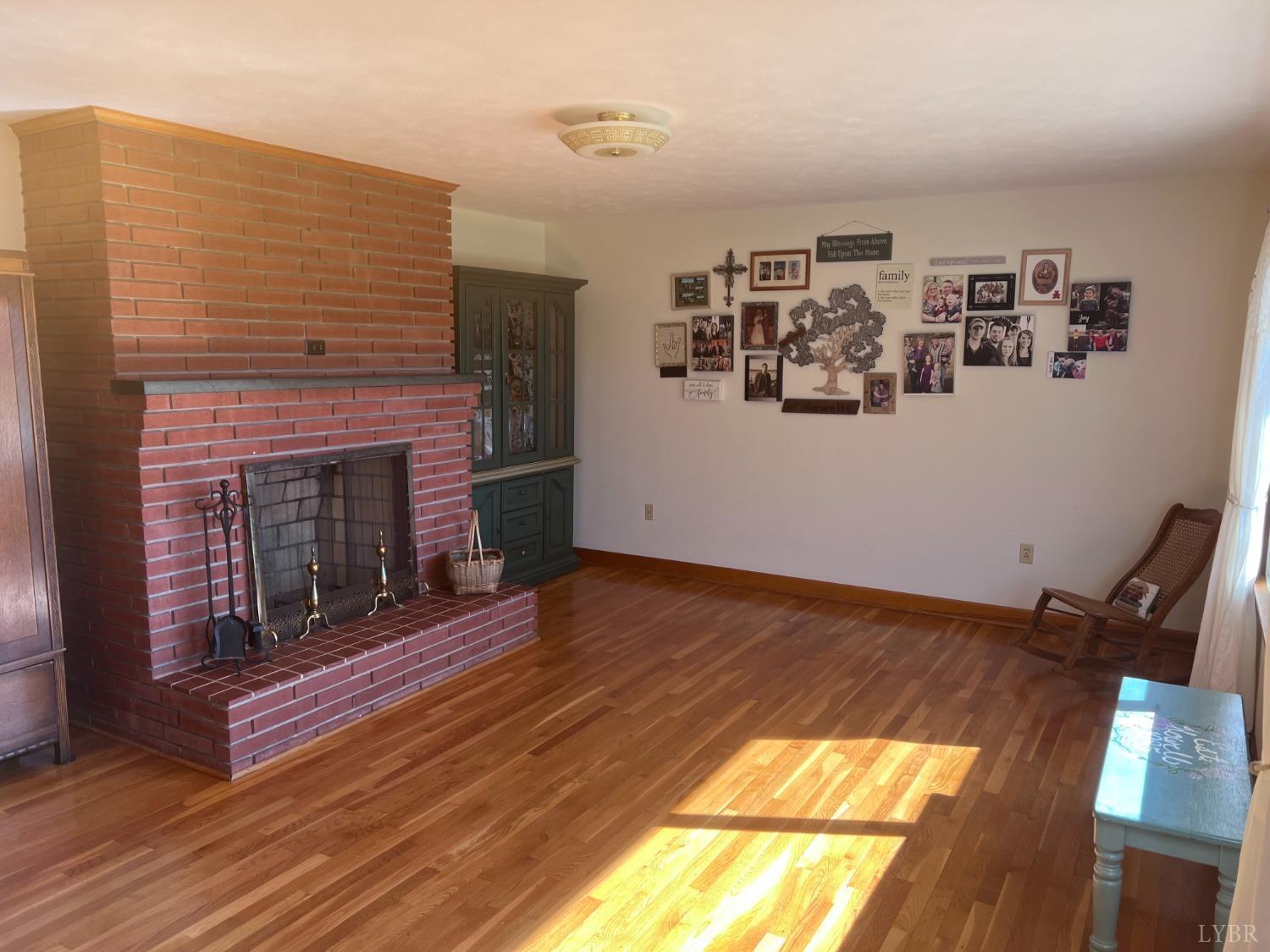 1930 Homeplace Road Rustburg, VA 24588 - Photo 15 of 88 Welcoming Living Room with lots of natural light and a wood burning fireplace.
