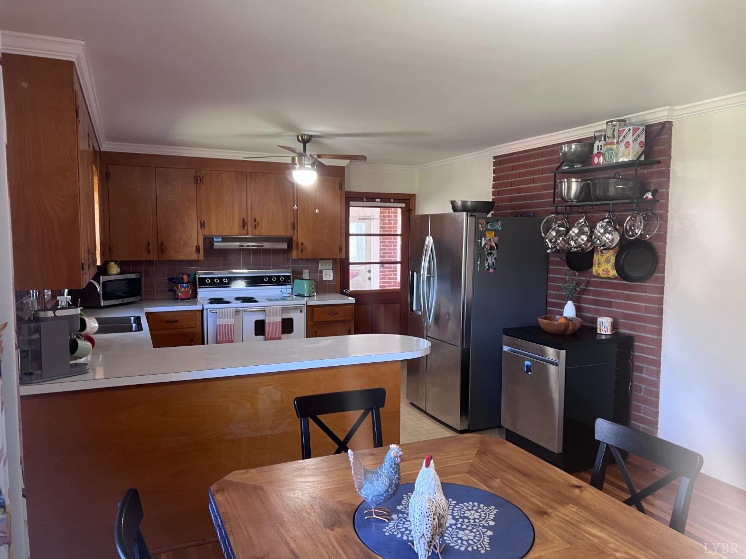 1930 Homeplace Road Rustburg, VA 24588 - Photo 21 of 88 a kitchen with stainless steel appliances granite countertop a refrigerator a stove and a refrigerator with wooden floor