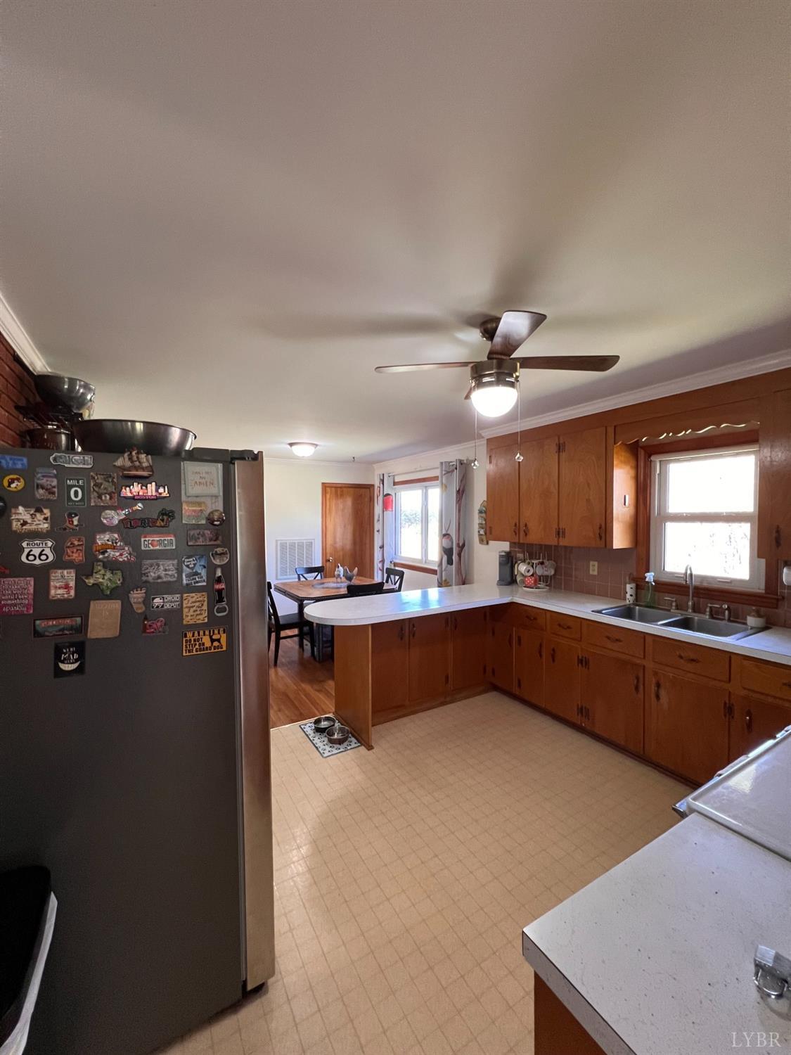 1930 Homeplace Road Rustburg, VA 24588 - Photo 22 of 88 a kitchen with stainless steel appliances granite countertop a refrigerator a sink dishwasher a stove and a dining table with wooden floor
