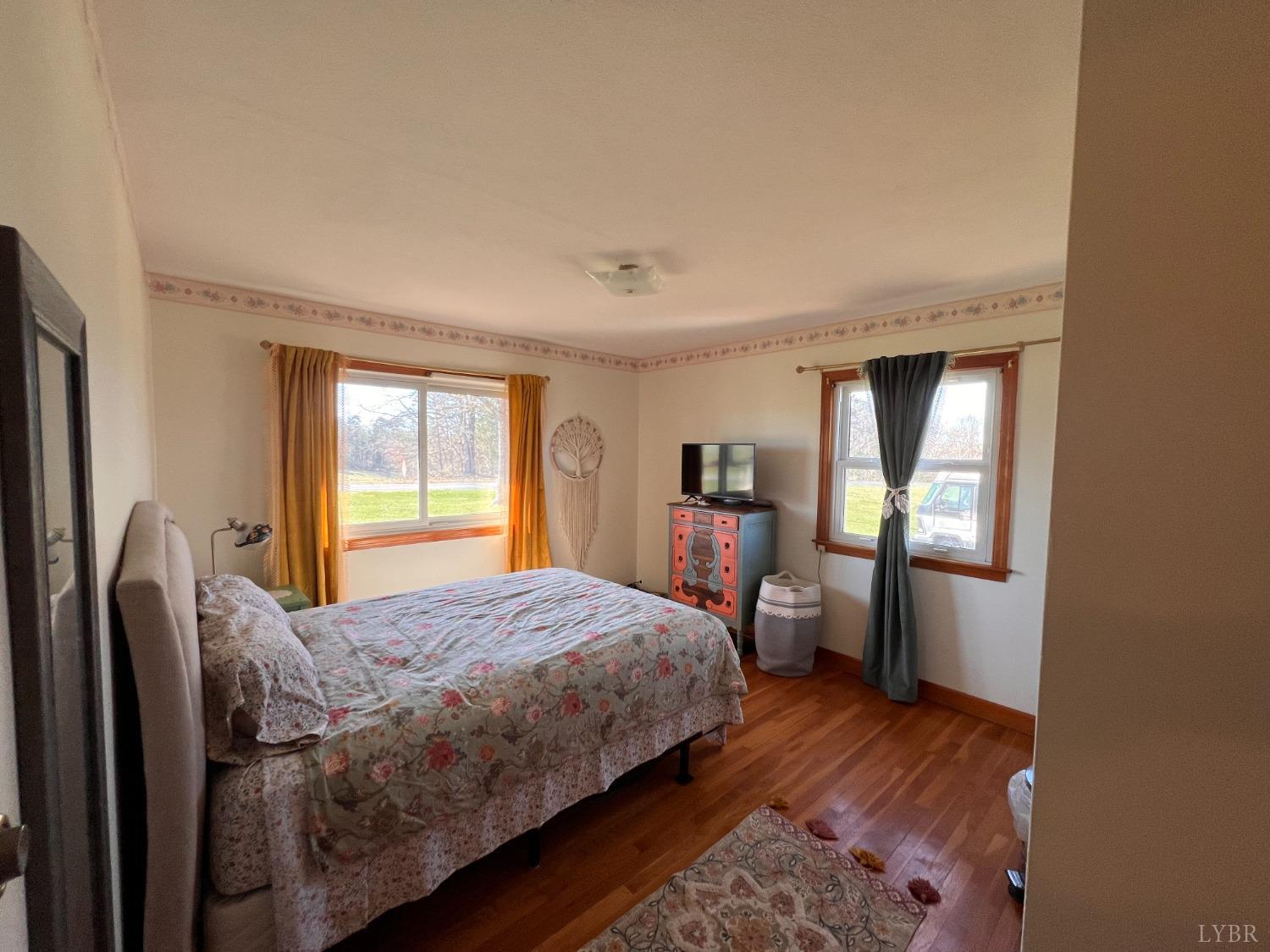 1930 Homeplace Road Rustburg, VA 24588 - Photo 36 of 88 a bedroom with a bed and wooden floor
