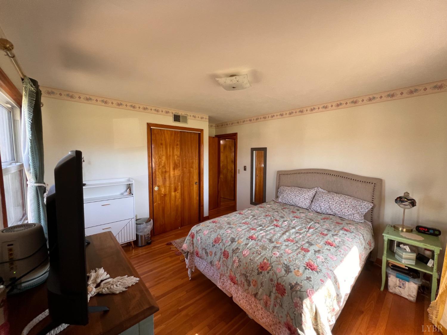 1930 Homeplace Road Rustburg, VA 24588 - Photo 37 of 88 a bedroom with a bed and wooden floor