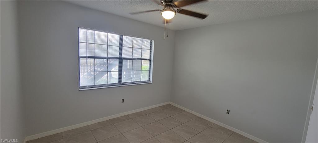 5233 Treetops Drive, Unit Y102 Naples, FL 34113 - Photo 5 of 9 an empty room with a window