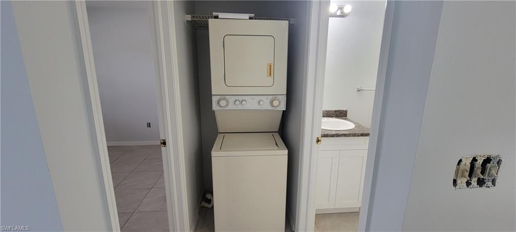 5233 Treetops Drive, Unit Y102 Naples, FL 34113 - Photo 6 of 9 a utility room with dryer and washer