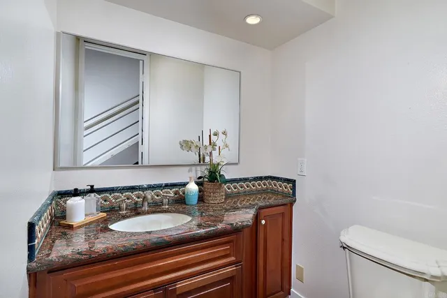 a bedroom with a bed flat screen tv and window