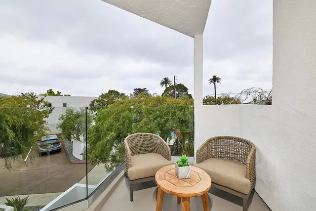 a bathroom with a granite countertop sink a mirror and a potted plant