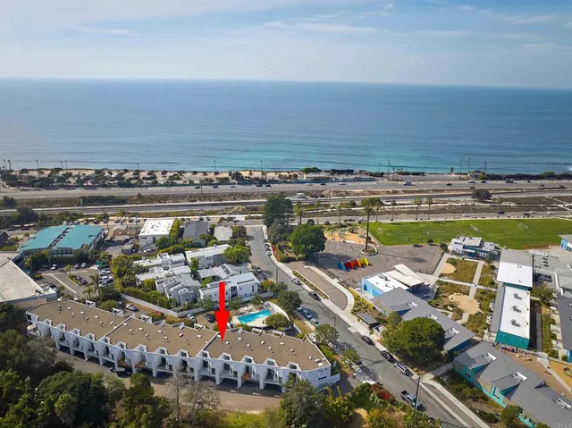 a view of swimming pool with a table and chairs in the background