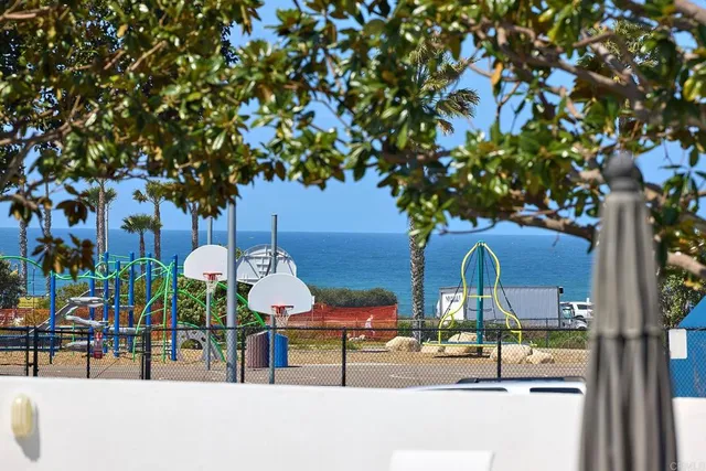 a view of tall building with large trees