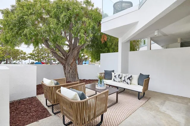 a outdoor living space with furniture and a rug