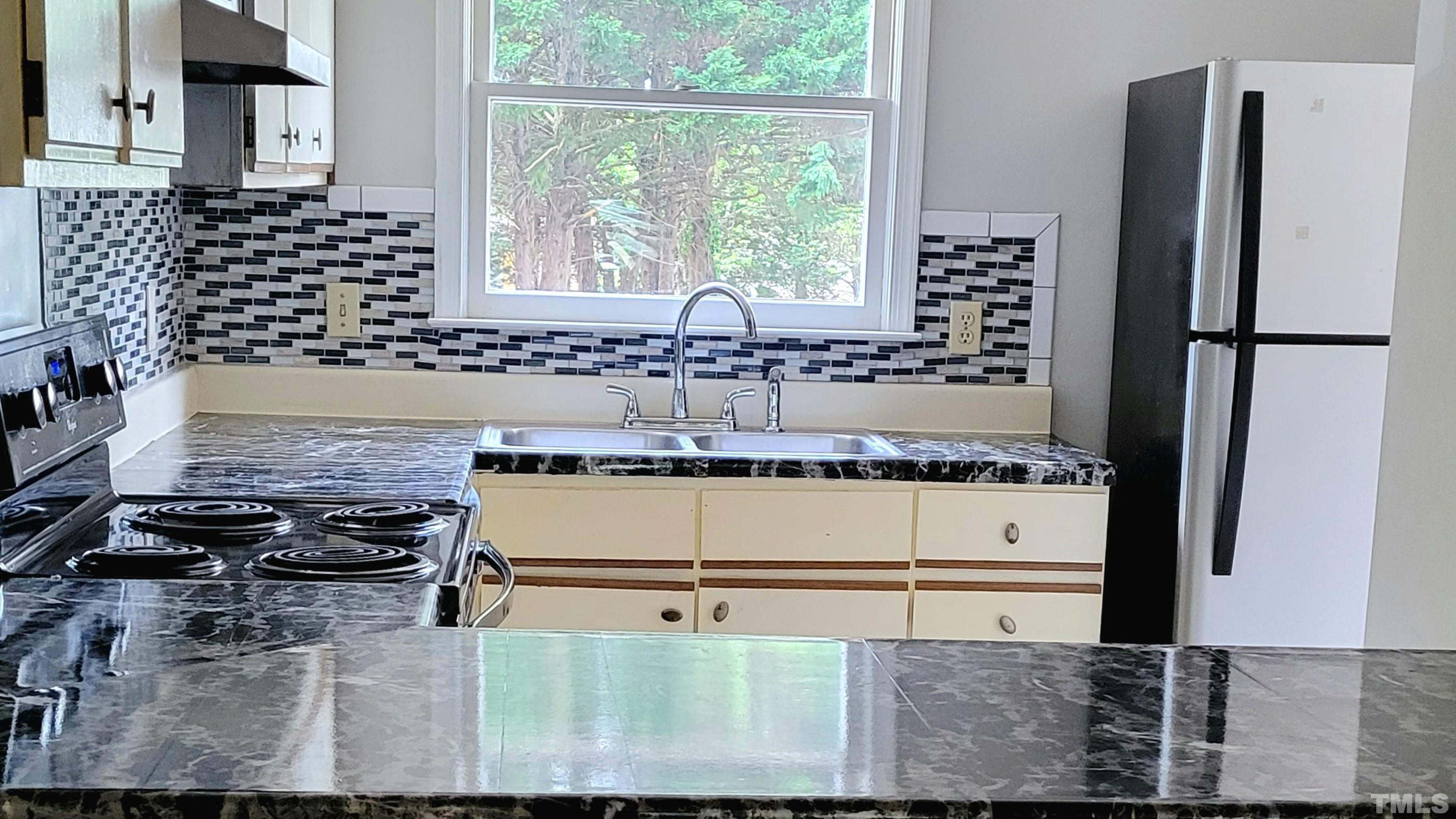 4362 Bona Court Raleigh, NC 27604 - Photo 3 of 17 a kitchen with a refrigerator and a stove