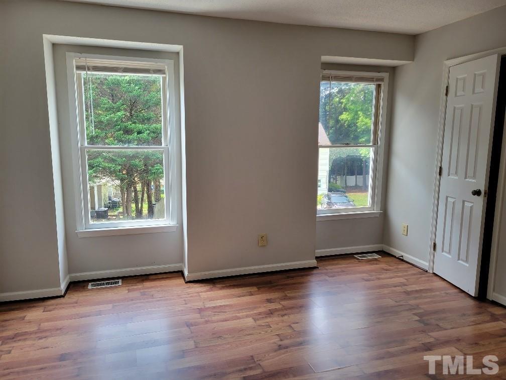 4362 Bona Court Raleigh, NC 27604 - Photo 5 of 17 an empty room with wooden floor and windows