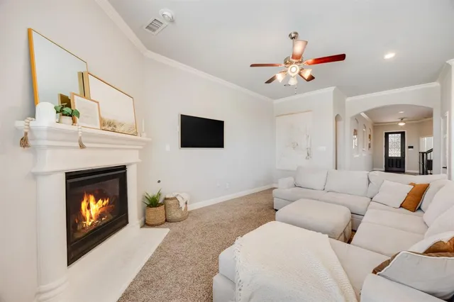 a living room with furniture a fireplace and a flat screen tv