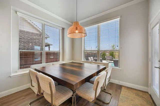 a view of a dining room with furniture window and wooden floor
