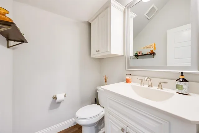 a bathroom with a sink toilet and mirror