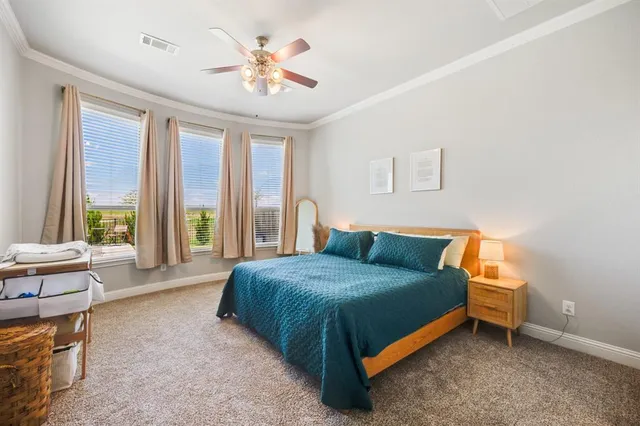 a bedroom with a bed and a large window