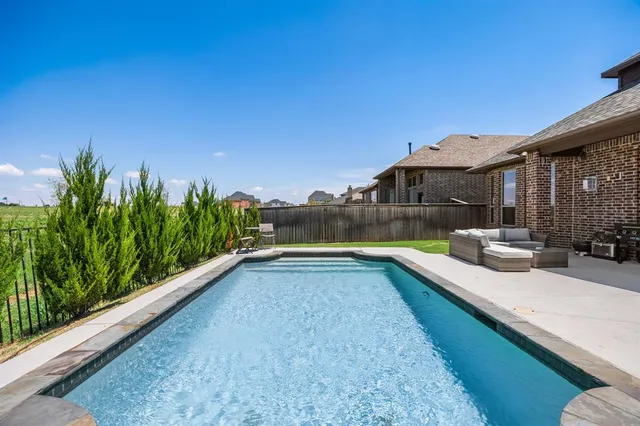 a view of a backyard with a tub and lake view