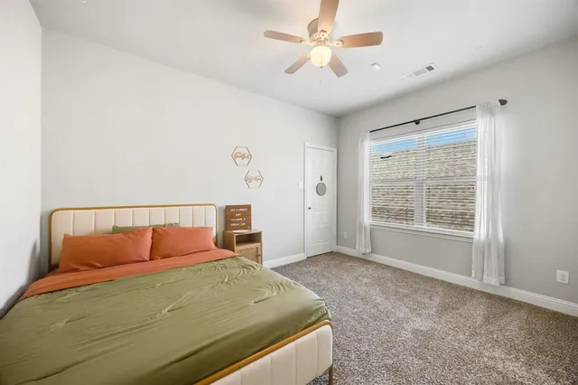 a bedroom with a large bed and a window