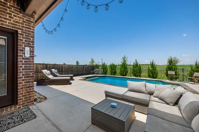 a view of a terrace with couches and a flat screen tv